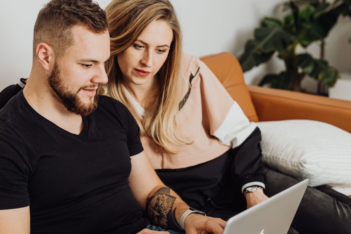 People using a laptop together at home
